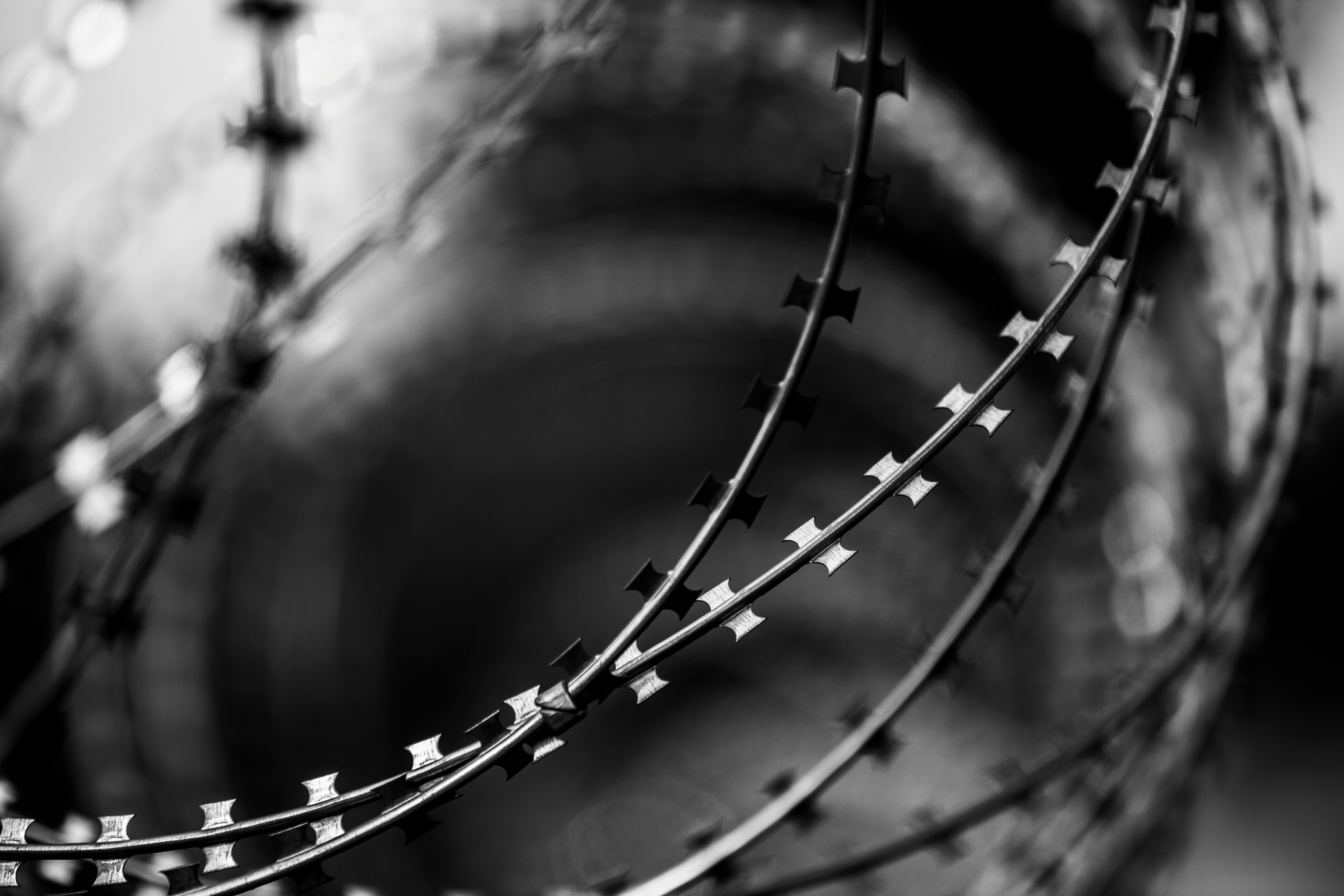 grayscale photo of metal spiral stairs